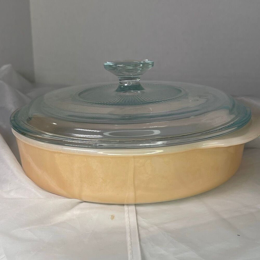 Vintage Fire King Peach Luster Casserole dish with glass lid.